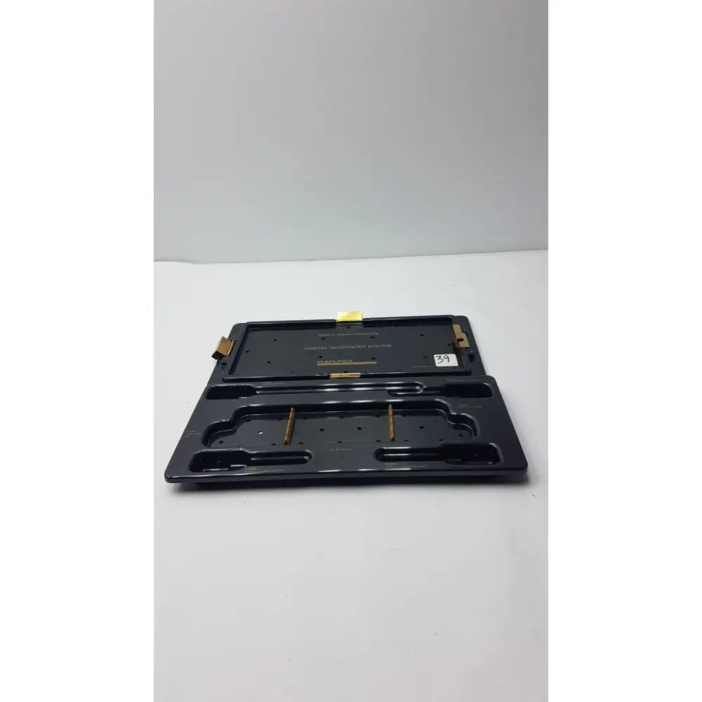 Black plastic smith & nephew endoscopy portal accessory tray with gold metal components and molded compartments
