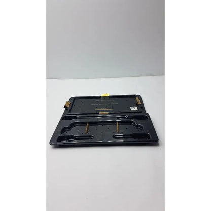 Black plastic smith & nephew endoscopy portal accessory tray with gold metal components and molded compartments