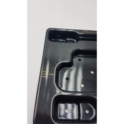 Black plastic tool tray with molded compartments for organizing tools in smith & nephew endoscopy portal accessory system
