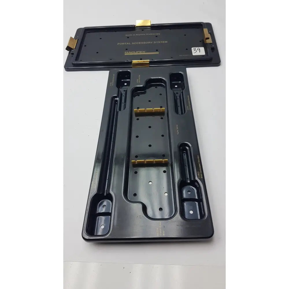 Black plastic smith and nephew endoscopy portal accessory system tray with gold metal components and molded slots
