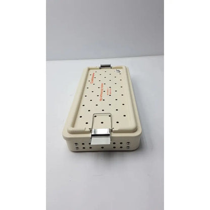 Beige plastic hip arthroscopy empty tray with metal clasp and perforated lid smith & nephew ref 7207934