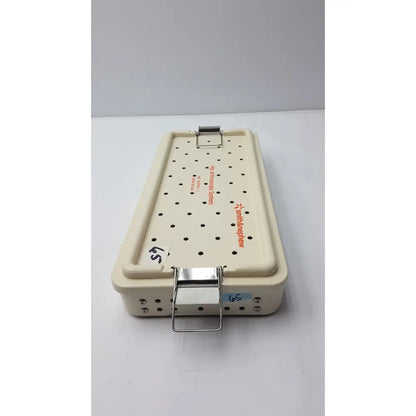 Cream-colored Smith & Nephew ref 7207934 hip arthroscopy empty tray with perforated surface and metallic clasp