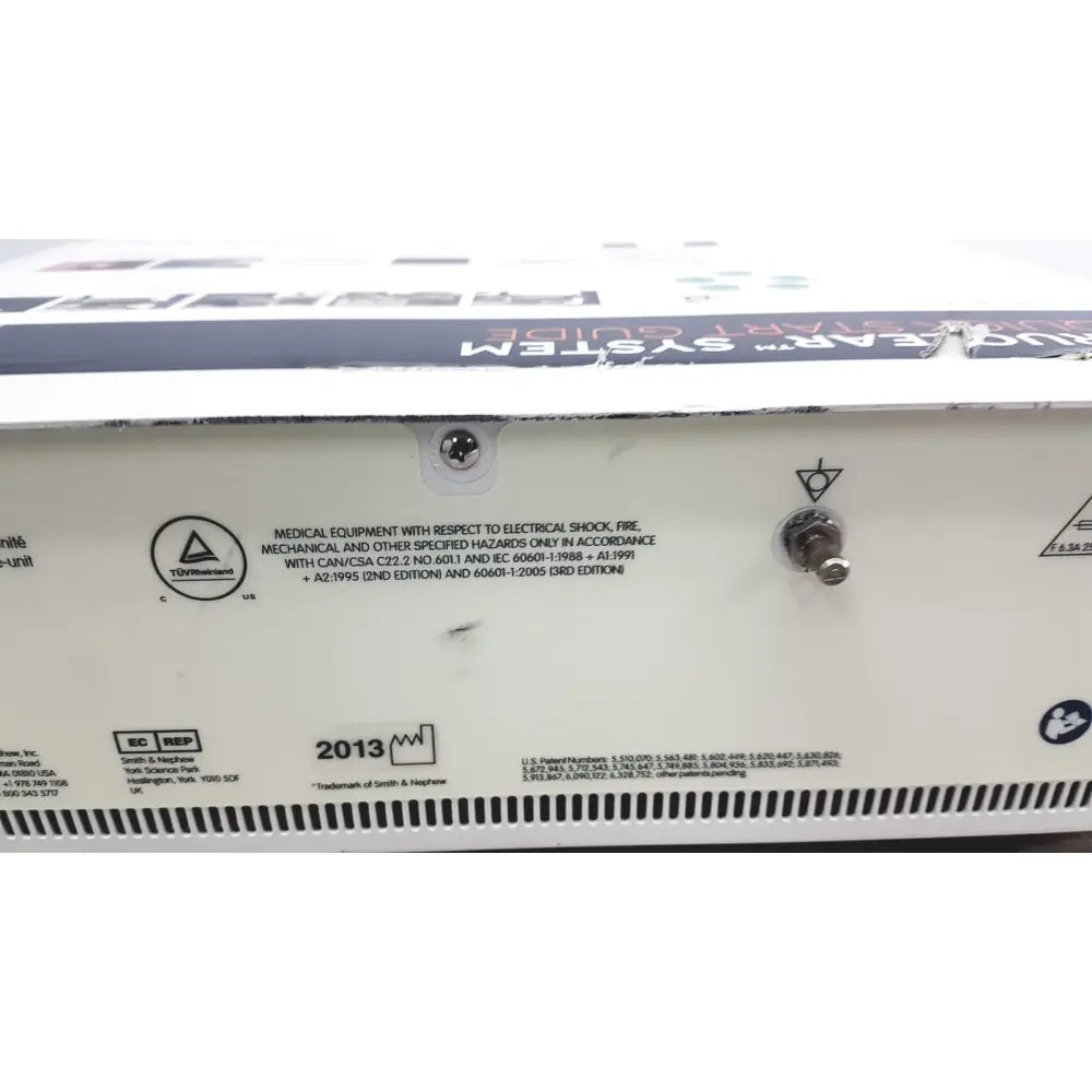 White rectangular back panel of the nephew truclear hysteroscopic morcellator console with regulatory labels and power switch