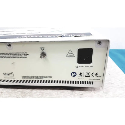 White rectangular nephew truclear hysteroscopic morcellator console back with black power input port and safety labels