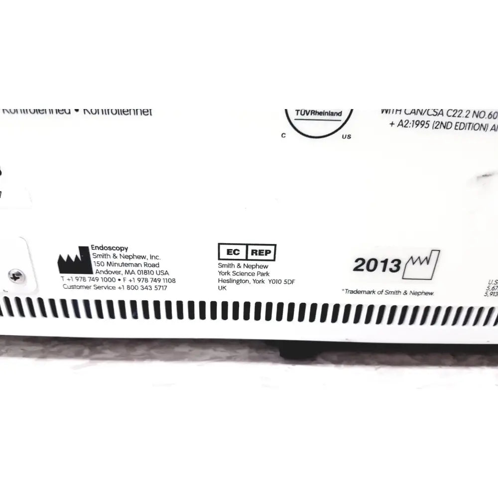 White plastic device label with black text and smith and nephew branding on nephew truclear hysteroscopic morcellator console