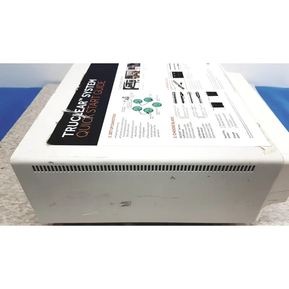 White plastic smith & nephew truclear hysteroscopic morcellator console box with black and white instruction manual attached