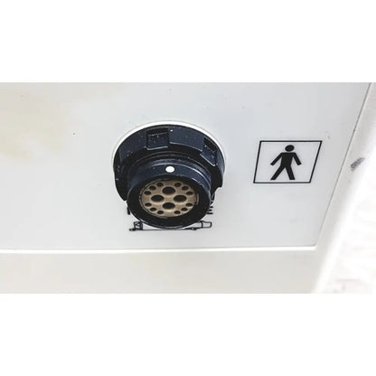 Black circular electrical connector with metallic pins and white dot on back side of smith & nephew truclear hysteroscopic morcellator console
