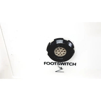 Black circular footswitch with metallic perforated center labeled footswitch for smith & nephew truclear hysteroscopic morcellator console