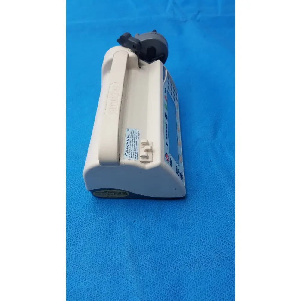 White and gray smiths medfusion 3500 medical infusion pump with digital display and rotating pole clamp attached to iv bag