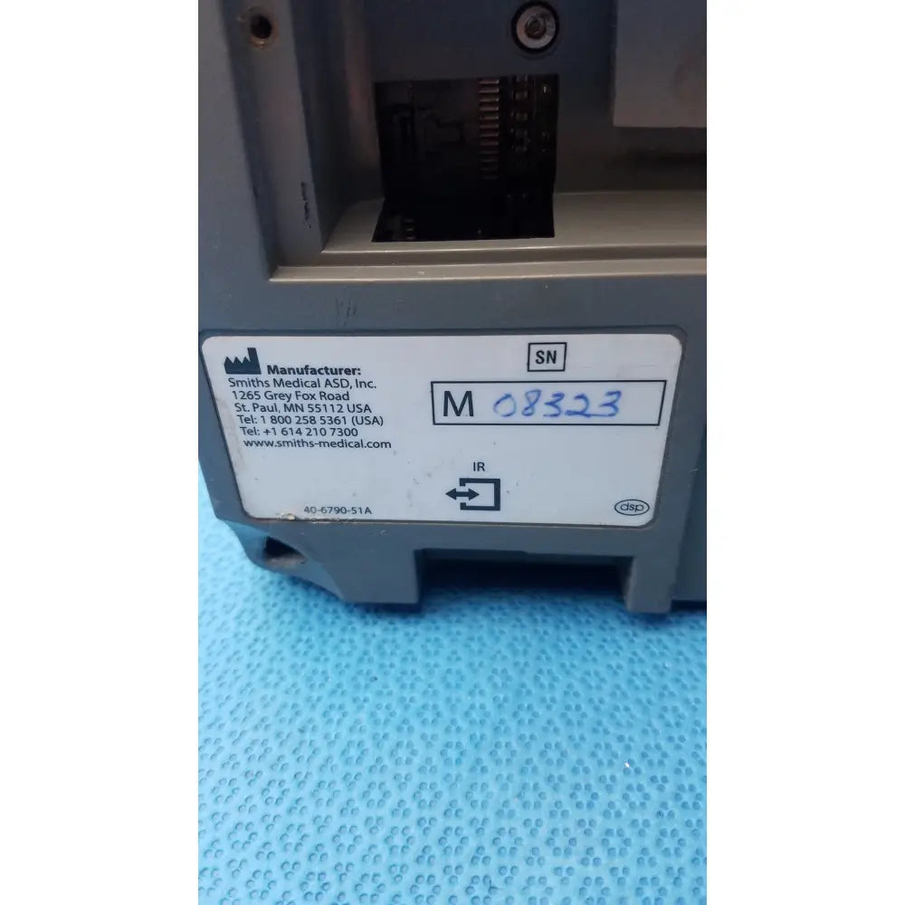 Gray plastic smiths medfusion 3500 medical device with rotating pole clamp and manufacturer label visible on back side