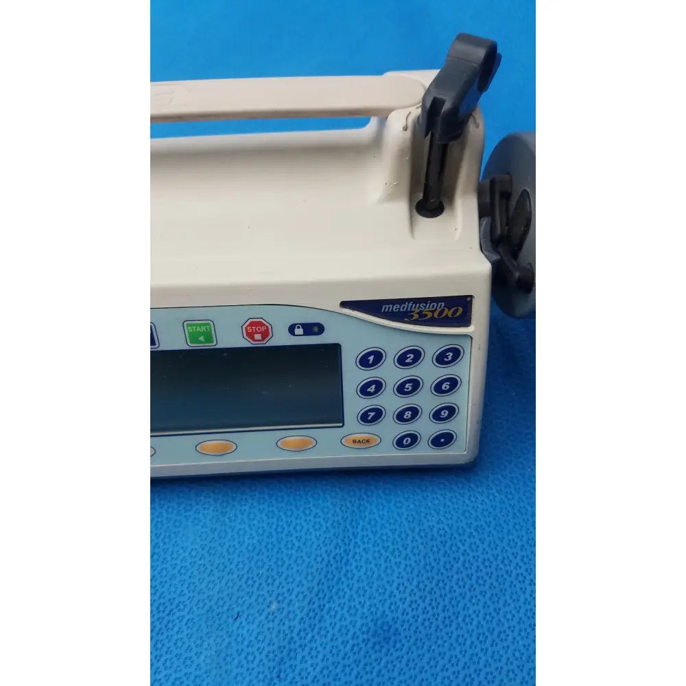 Medical infusion pump smiths medfusion 3500 with beige casing blue control panel and rotating pole clamp