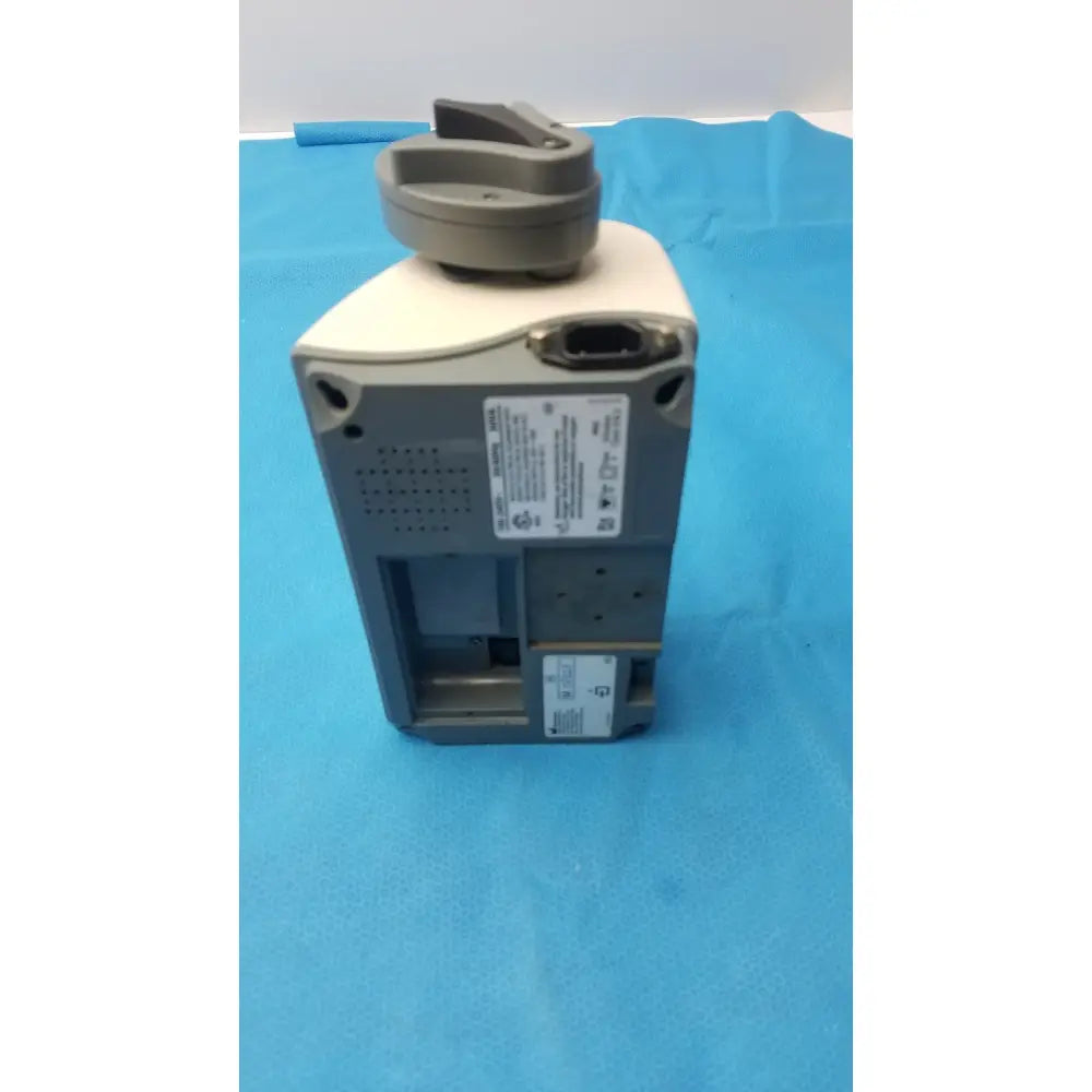 Gray and beige smiths medfusion 3500 medical device with circular top handle and rotating pole clamp for secure mounting