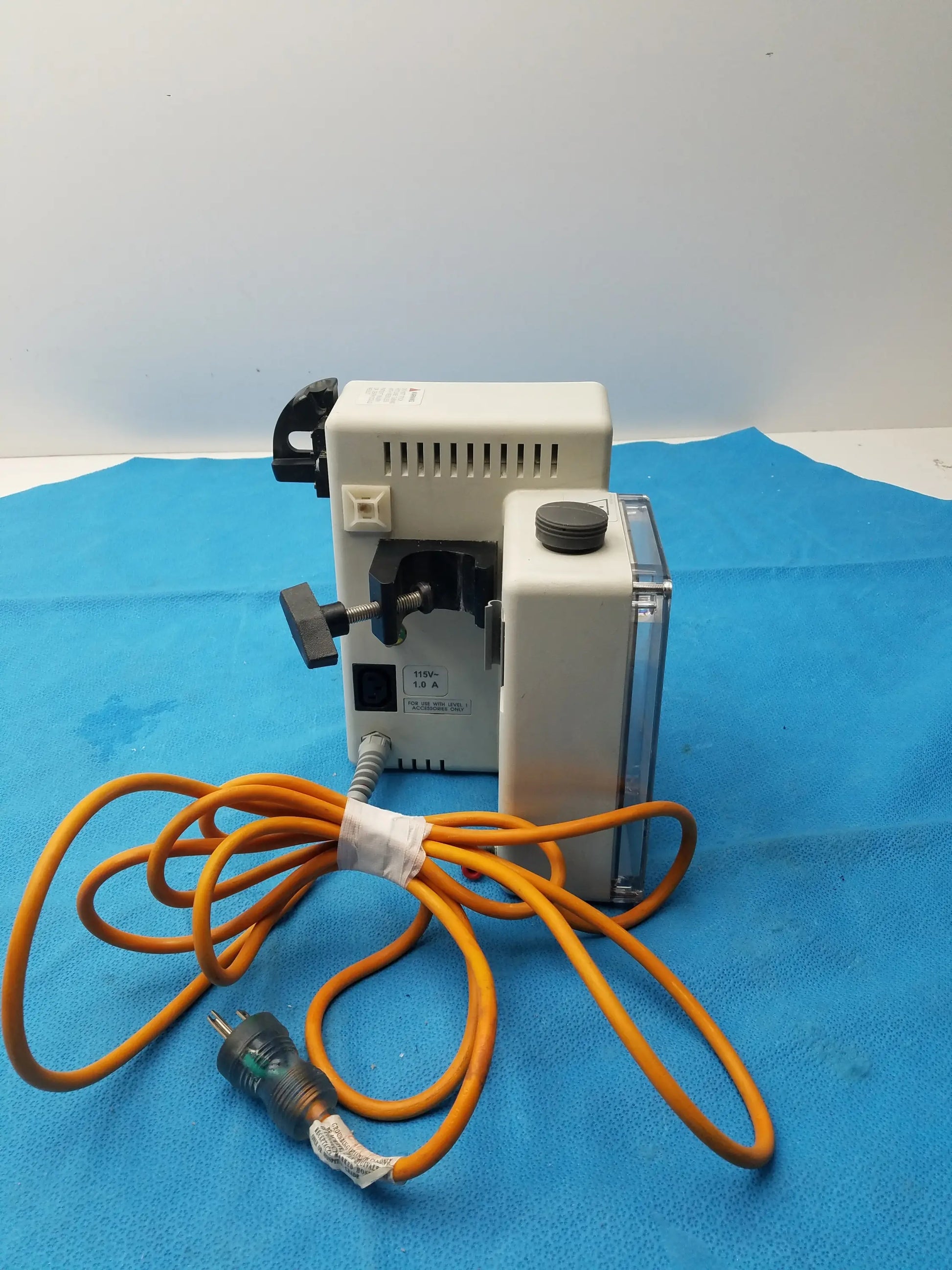 White plastic dental handpiece with black accents and coiled orange cord for smiths medical fluid warmer control box unit
