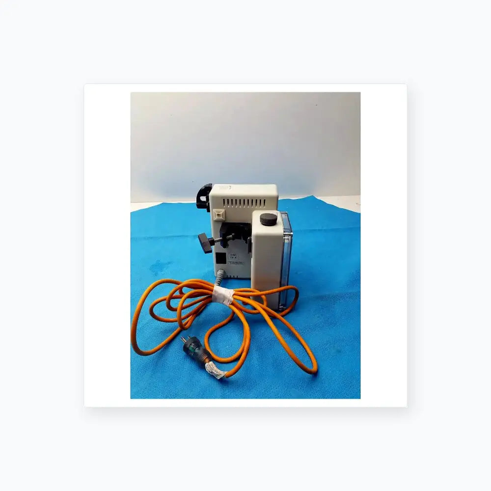 White plastic dental handpiece with black accents and coiled orange cord for smiths medical fluid warmer control box unit