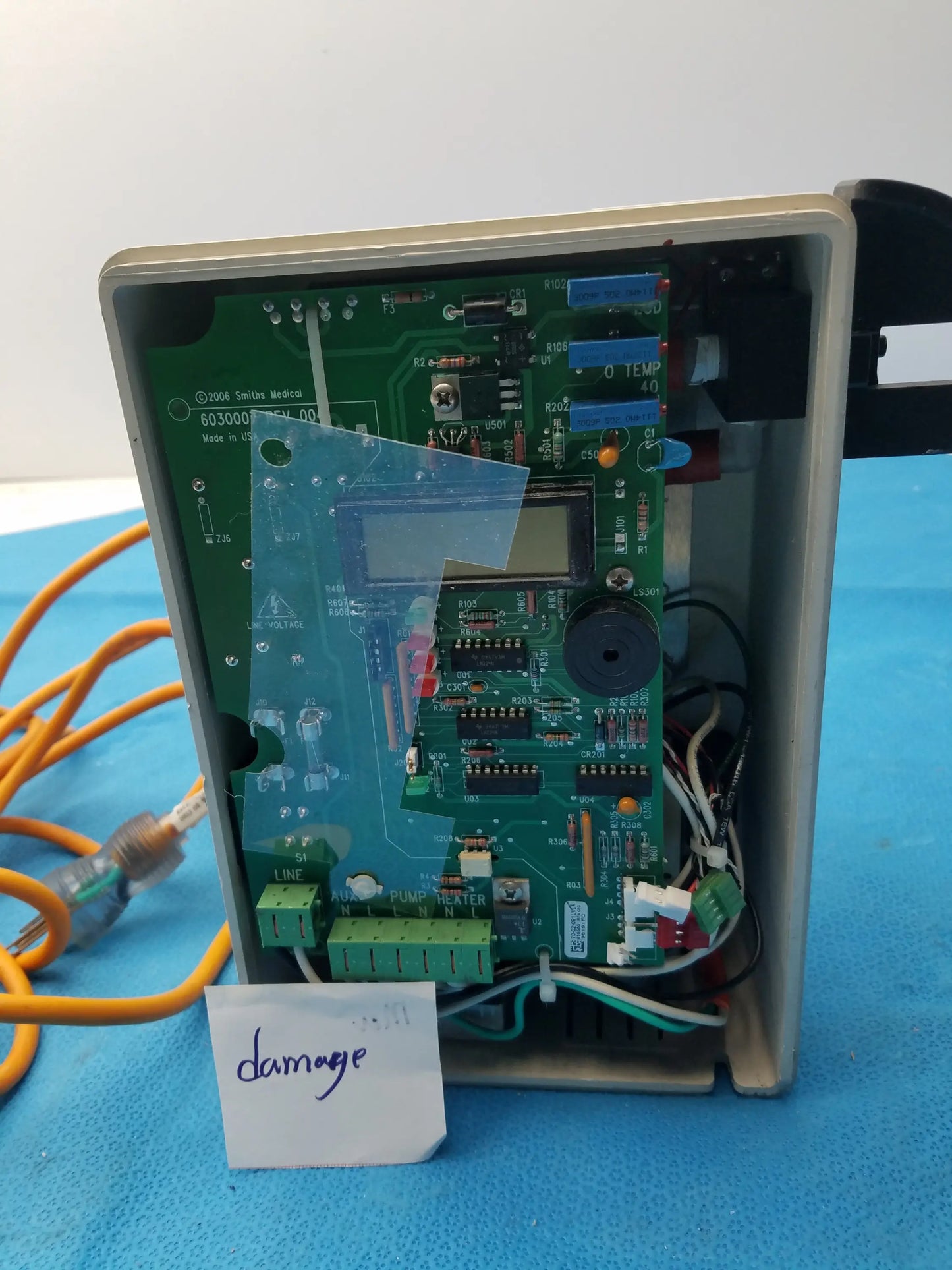 Green circuit board with electronic components and small screen in beige plastic enclosure for smiths medical fluid warmer unit