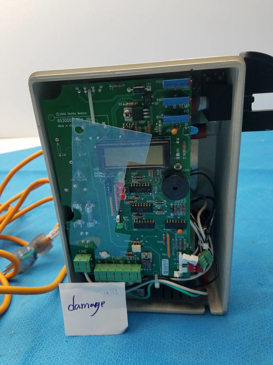 Green circuit board with electronic components and small screen in beige plastic enclosure for smiths medical fluid warmer unit