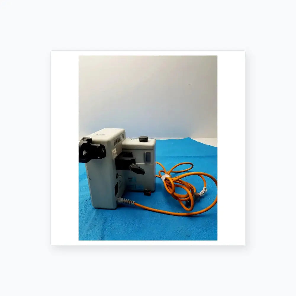 Gray metallic smiths medical fluid warmer control box unit with black components and coiled orange power cord for medical equipment