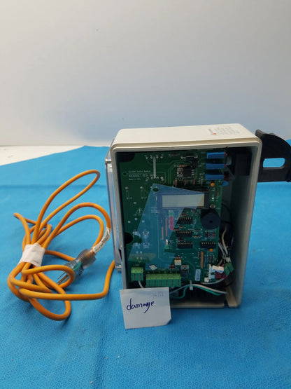 Beige plastic housing showing the green circuit board with blue connectors and orange coiled cable in smiths medical 6030007 fluid warmer control box unit
