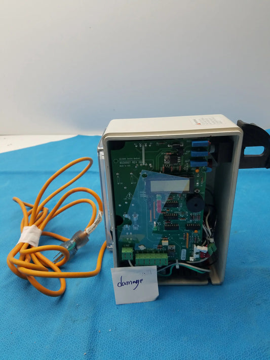 Beige plastic housing showing the green circuit board with blue connectors and orange coiled cable in smiths medical 6030007 fluid warmer control box unit