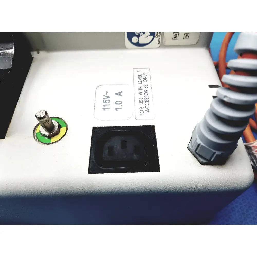 White plastic power outlet with black insert and green-yellow reset button on smiths medical hl-390 fluid warmer