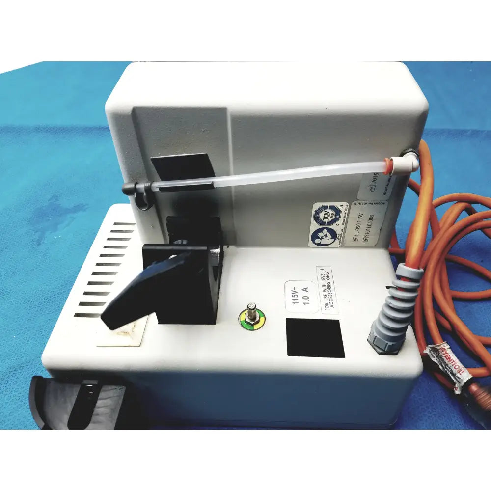 White plastic dental handpiece with black components and orange power cord for smiths medical hl-390 fluid warmer medical equipment