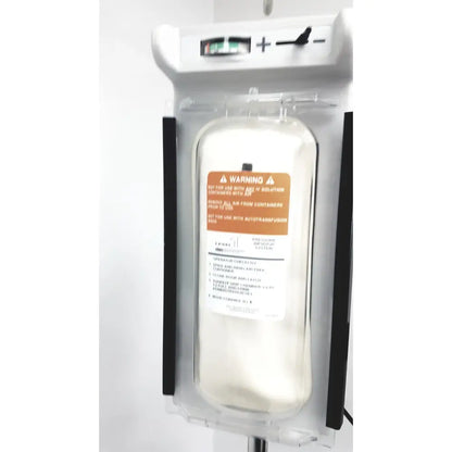 Clear plastic iv bag with orange warning label in a white smiths medical level 1 fluid warming system infusion pump