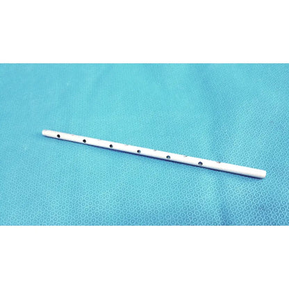 White plastic flute with seven black circular finger holes shown with snowden pencer pretzel articulating retractor product