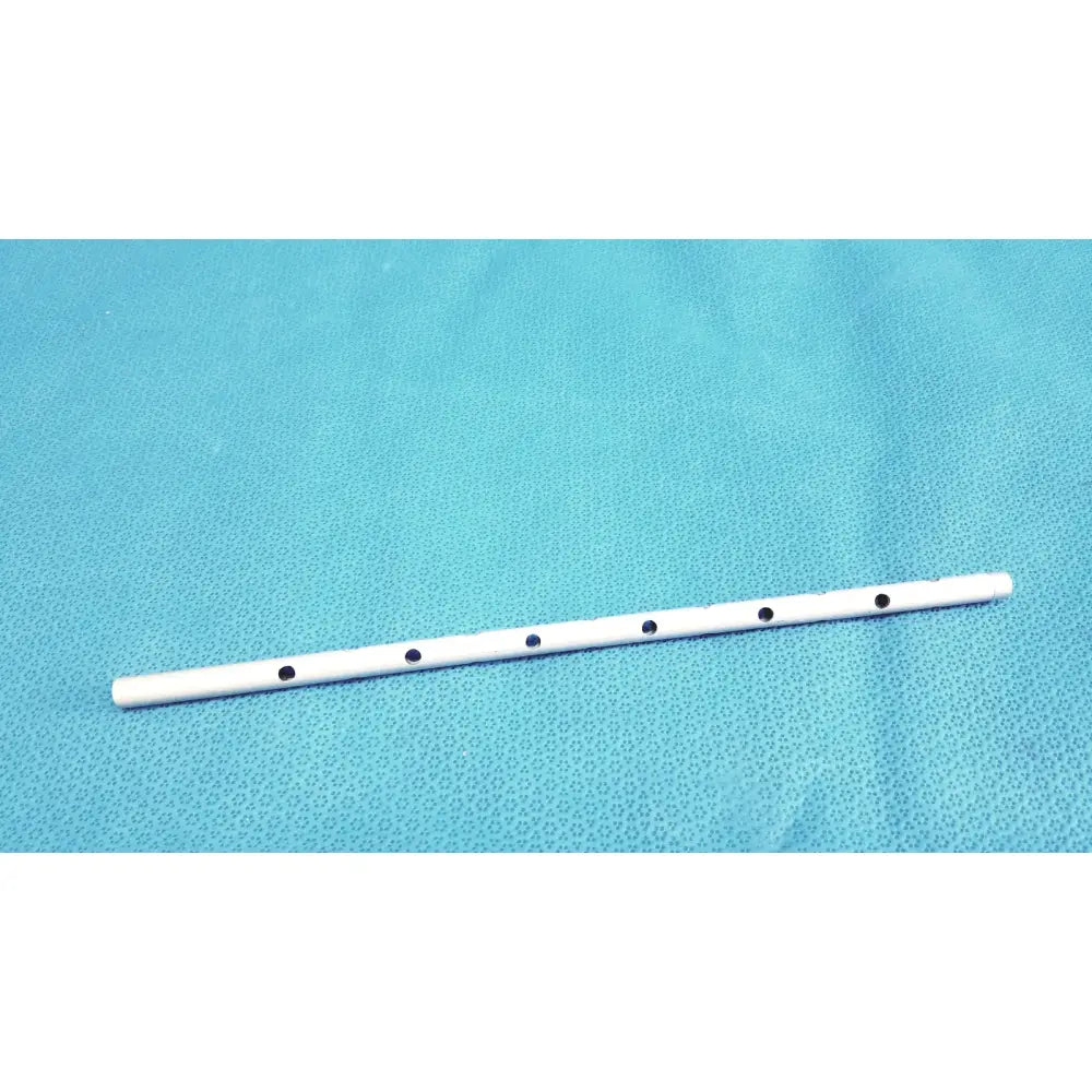 White plastic flute with five black circular finger holes part of snowden pencer pretzel articulating retractor