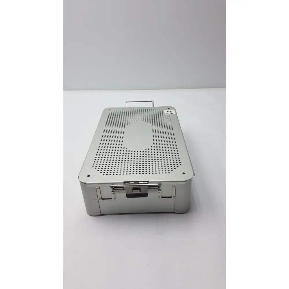 Solid brass sterilization storage container in silver metallic with perforated lid and sturdy handle for surgical use