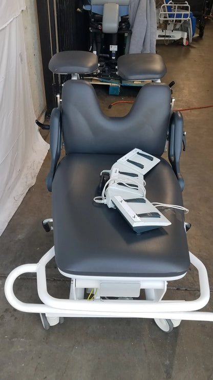 Black padded sonesta s3 ultimate patient positioning procedure chair with white metal frame and adjustable headrest