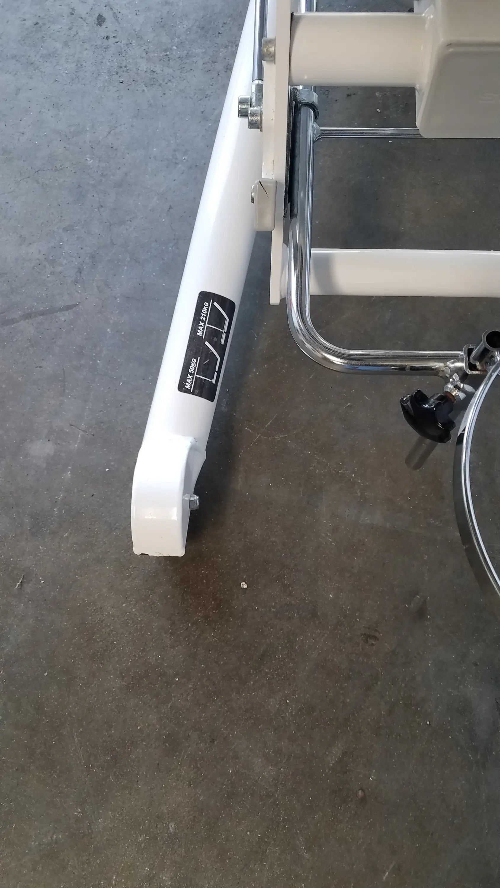 White metal leg with chrome accents and black knobs of the Sonesta S3 ultimate patient positioning procedure chair