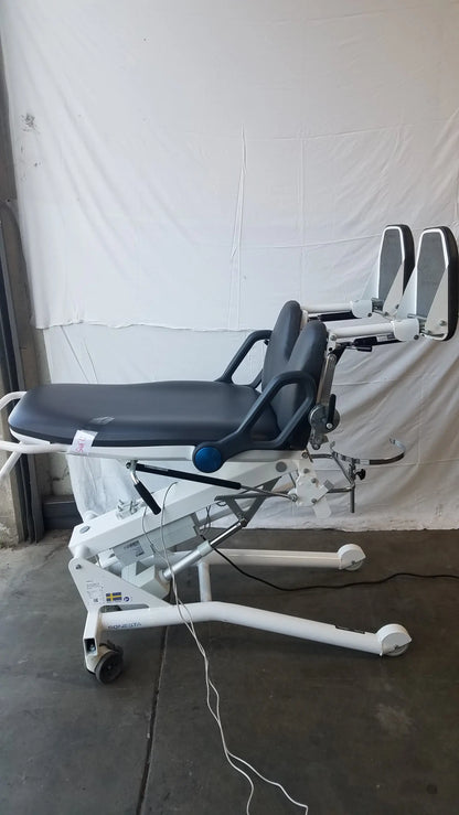 Sonesta s3 ultimate patient positioning procedure chair with white and black padded surface metal frame and wheels for mobility