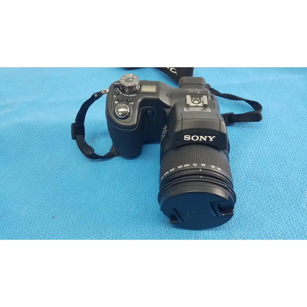Black sony cyber-shot dsc-f828 digital camera with zoom lens textured grip and silver dials with ac power adapter