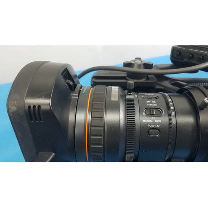 Black professional camera lens with orange ring and manual autofocus controls for sony pmw-300 memory xdcam camcorder