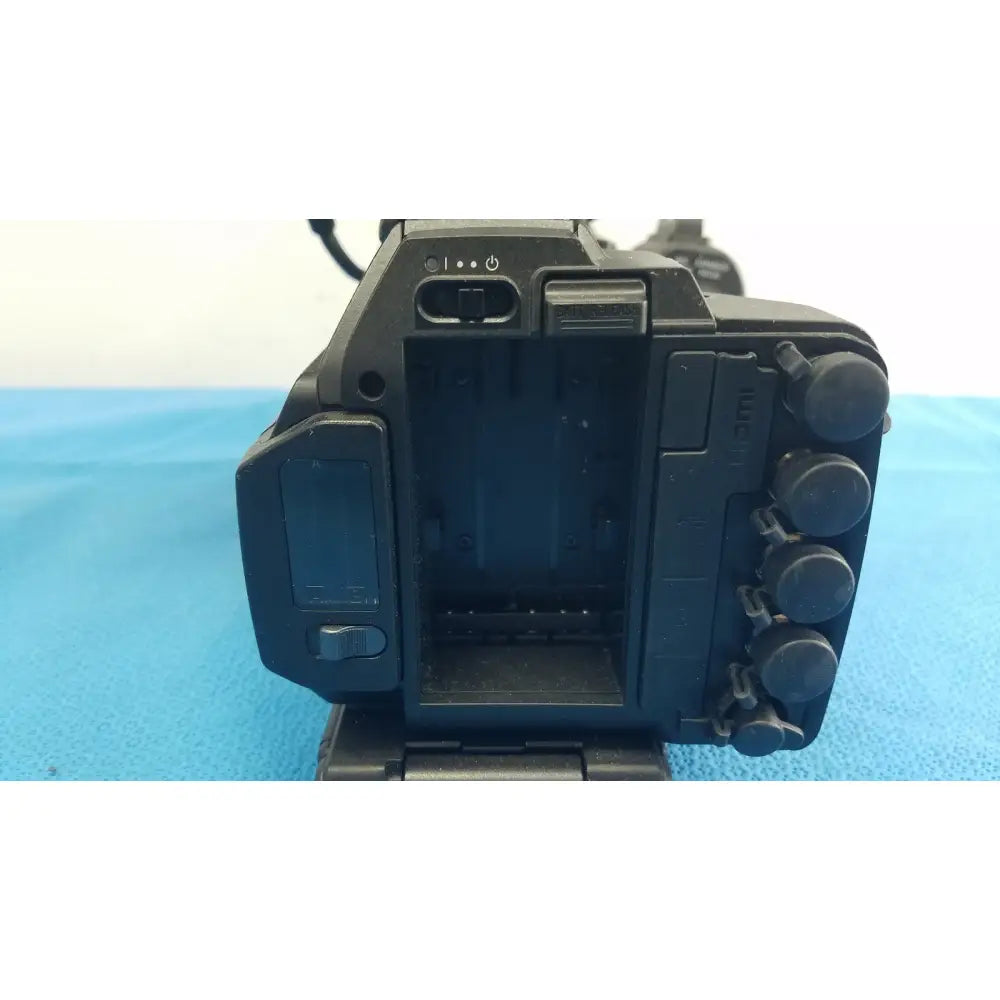 Black plastic sony pmw-300 memory xdcam camcorder body with control dials and battery compartment visible