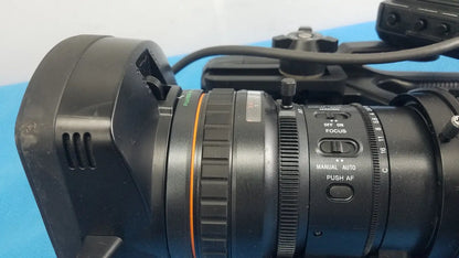 Black professional camera lens with orange ring and manual autofocus controls for sony pmw-300 memory xdcam camcorder