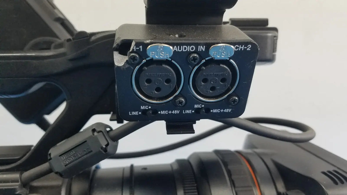 Black audio input module with two xlr connectors and blue push buttons on the back of sony pmw-300 memory xdcam camcorder