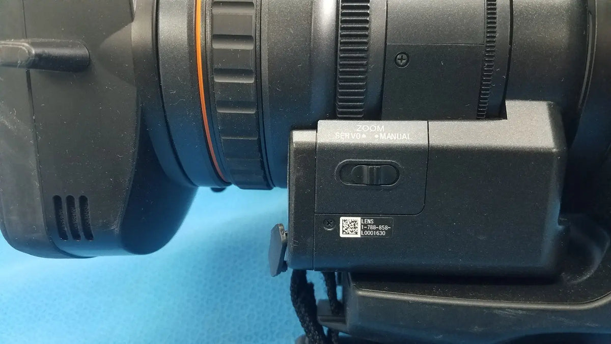 Black camera lens with zoom servo manual switch and qr code label on sony pmw 300 memory xdcam camcorder
