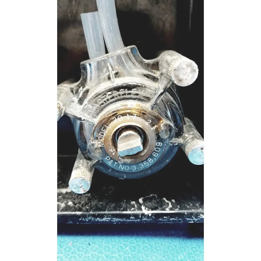 Clear plastic sorvall cell washer pump with metallic fittings and engraved model number for centrifuge cell washing system