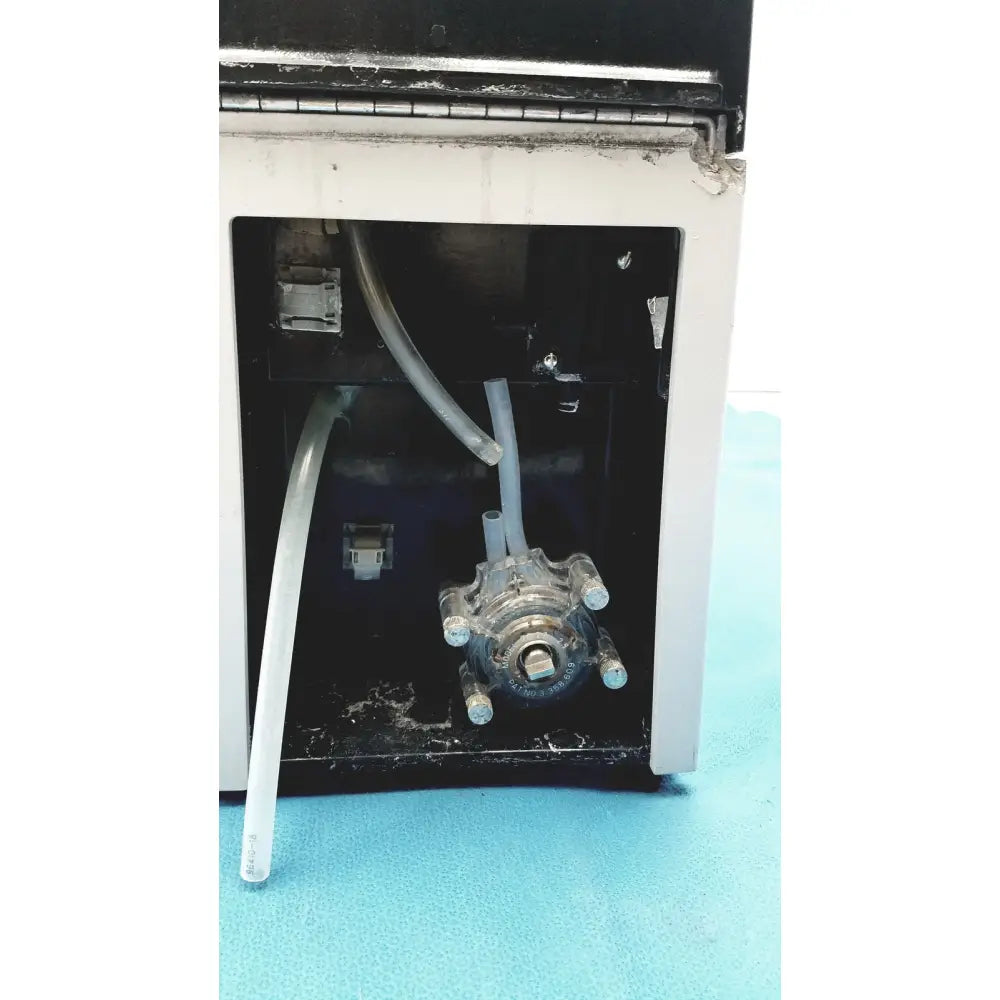 Clear plastic fluid pump with multiple threaded ports and tubing connected on sorvall cell washer centrifuge cell washing system