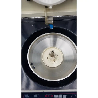 Silver metallic rotor with central white hub and screws inside black chamber of sorvall cell washer centrifuge cell washing system