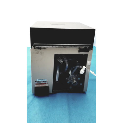 Gray and black sorvall instruments cell washer with transparent tubing and metallic components visible through open panel