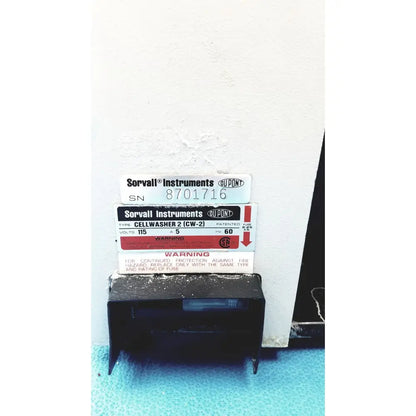Sorvall instruments cell washer 2 is a black plastic instruments cell washer unit with white and red labeling