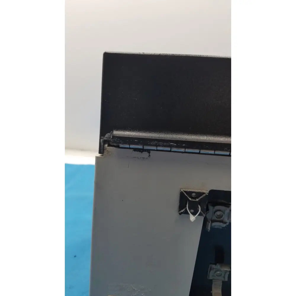 Black metal hinge with wear and silver latch on gray plastic housing of sorvall instruments cell washer 2 8701716