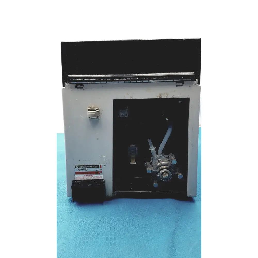 Gray metal sorvall instruments cell washer 2 with black top panel and visible tubing and valves internal components