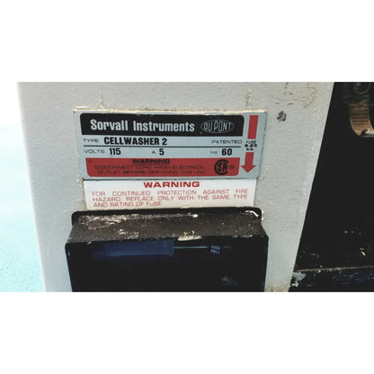 Sorvall instruments cell washer 2 is a white industrial laboratory equipment with black labels and red warning text