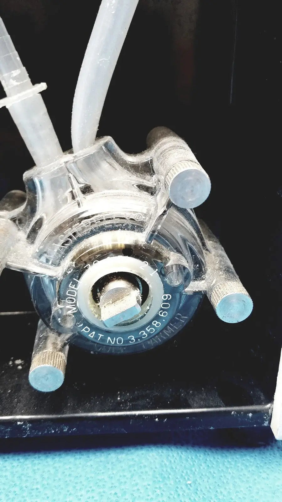 Clear plastic peristaltic pump with metallic fittings and blue tubing for Sorvall instruments cell washer 2