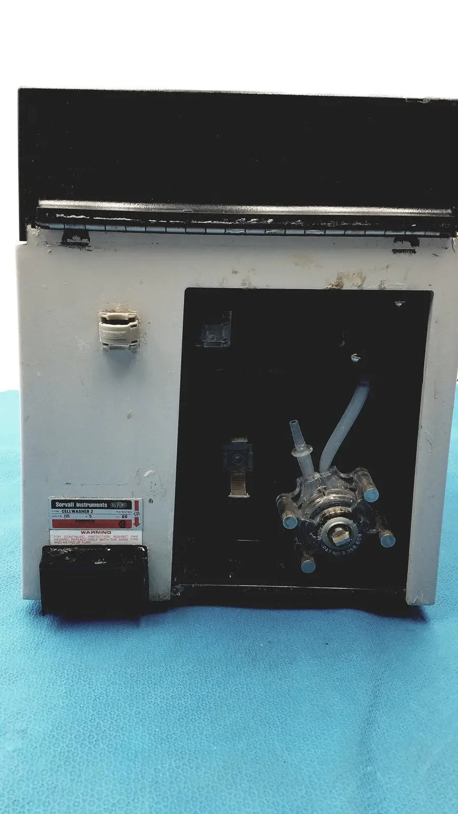 White and black sorvall instruments cell washer with metallic pump assembly for laboratory use