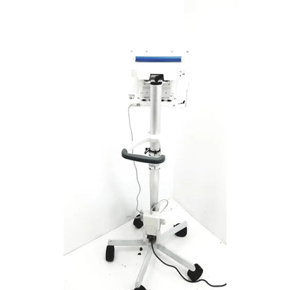 White medical examination table with blue bar and black wheels for spacelabs healthcare ultraview sl model patient monitor stand
