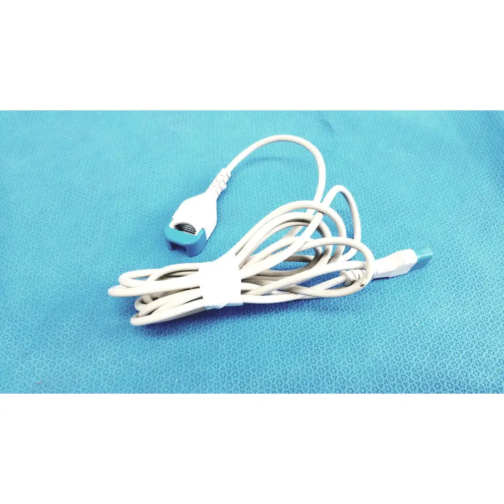 Spacelabs medical extension adapter cable 700-0030-00 white cable with teal connector and usb end coiled on blue surface